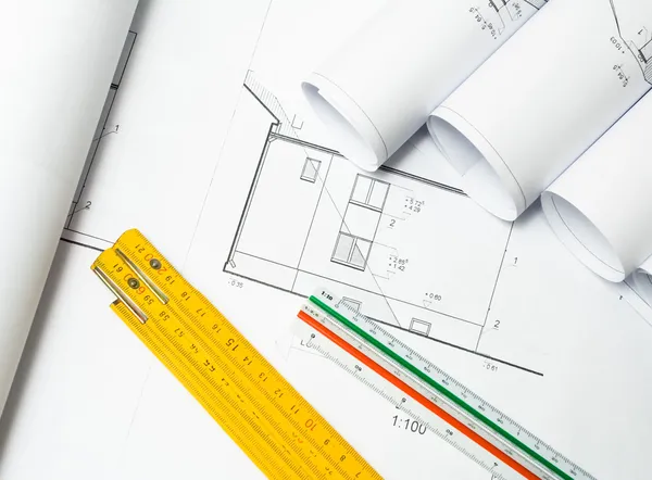 Architect blueprints on desk — Stock Photo, Image