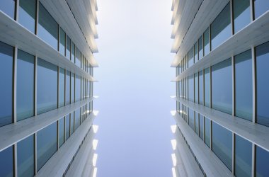 Exterior windows of two identical modern buildings clipart