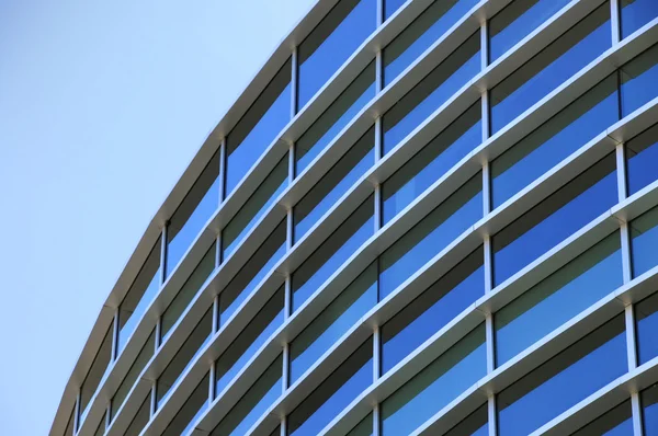 Curved exterior windows of a modern commercial office building — Stock Photo, Image