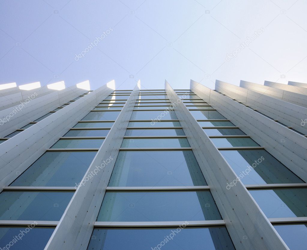 Exterior windows of modern commercial office building looking up