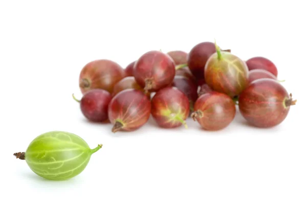 Pile of red gooseberries and one green — Stock Photo, Image