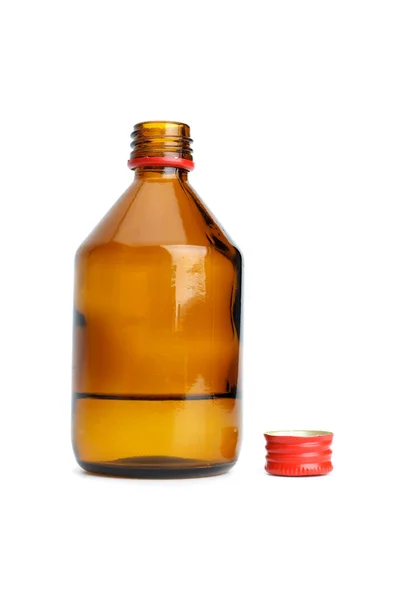 Bottle with liquid and cap near — Stock Photo, Image