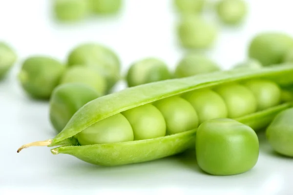Macro shot of cracked pod and green peas — Stock Photo, Image