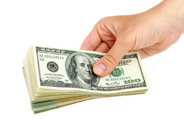 Hand giving pack of $100 banknotes — Stock Photo, Image