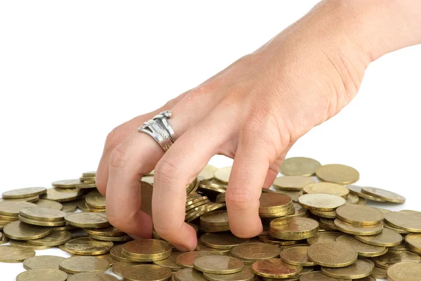 Hand grabbing coins from the pile — Stock Photo, Image