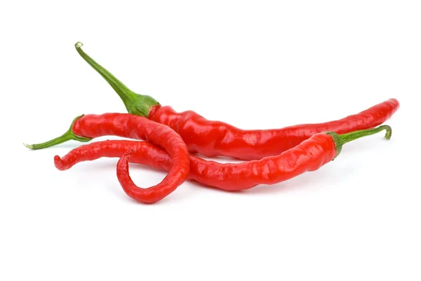 Three long curved red hot chili peppers — Stock Photo, Image