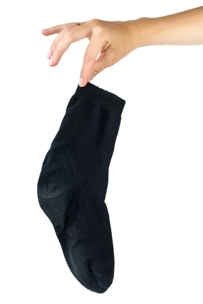 Mano sosteniendo calcetín negro sucio — Foto de Stock