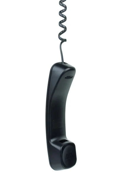 Black phone handset hanging on cord — Stock Photo, Image