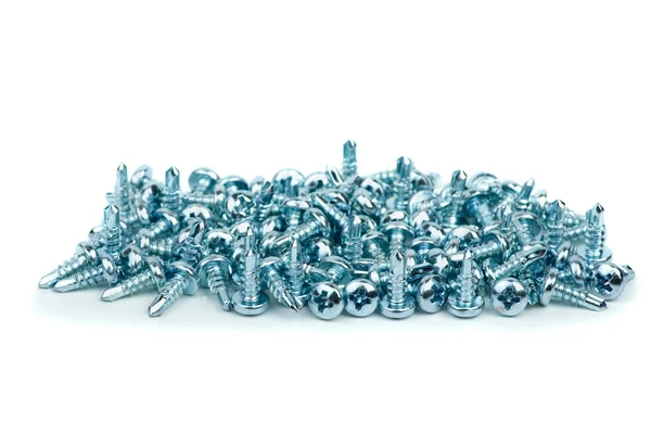 Pile of small silver colored metal screws — Stock Photo, Image