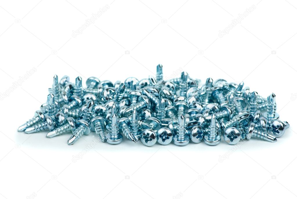 Pile of small silver colored metal screws