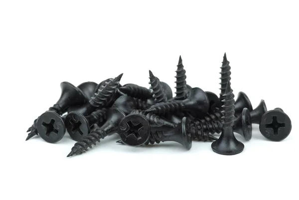 Крупный план кучи черных металлических винтов — стоковое фото