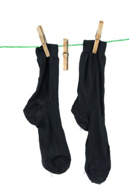 Two black socks hanging on rope clipart