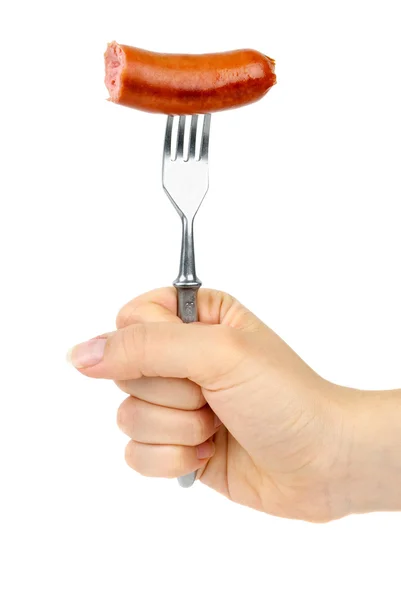 Mano che tiene mezza salsiccia mangiata sulla forchetta . — Foto Stock