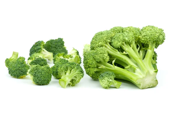 One big and few small broccoli pieces — Stock Photo, Image
