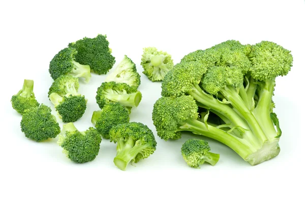 Um grande e poucos pedaços pequenos de brócolis — Fotografia de Stock