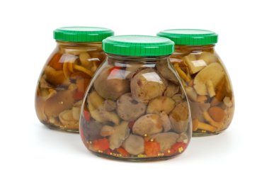 Glass jars with marinated mushrooms clipart