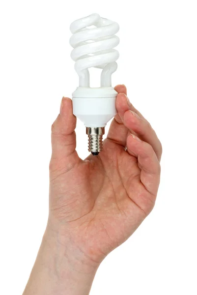 Hand met compacte spiraal-vormige fluorescentielamp — Stockfoto