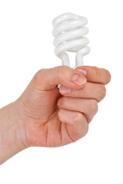 Spiral-shaped fluorescent lamp gripped in fist — Stock Photo, Image