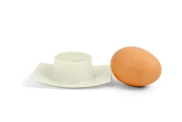 Brown boiled egg near eggcup — Stock Photo, Image