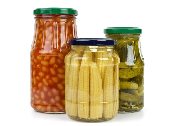 Glas jars with cornichons, haricot beans and corn ears — Stock Photo, Image