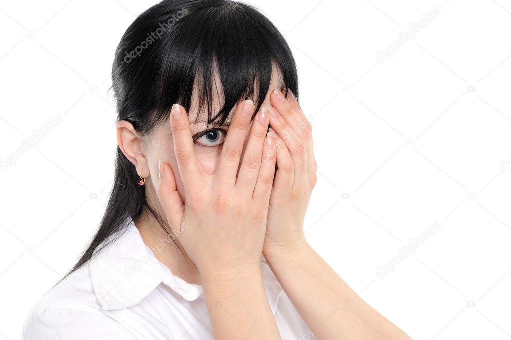 Woman is gazing through her fingers