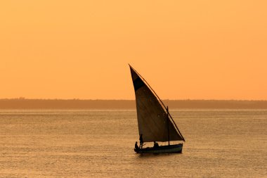 Mozambican dhow at sunset clipart