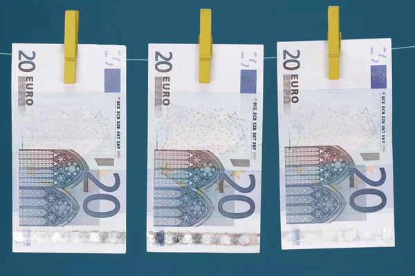 Three Euro bills hanging on clothesline — Stock Photo, Image