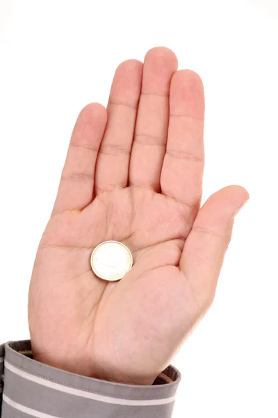 Una moneda en mano de hombre — Foto de Stock