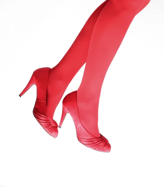 Slanke benen in rode kousen — Stockfoto