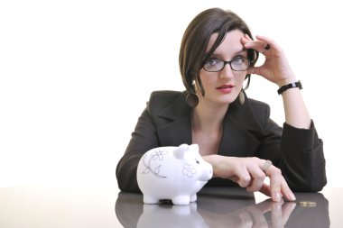 Woman putting coins in piggy bank clipart