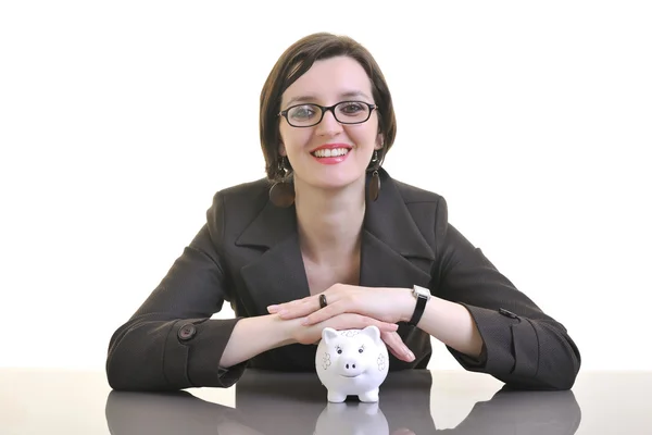 Woman putting coins in piggy bank — Stock Photo, Image