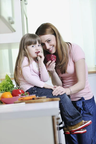 Happy daughter and mom in kitchen Royalty Free Stock Images