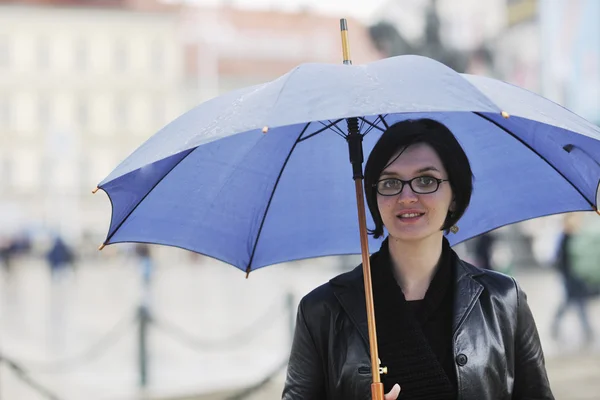 Woman on street with umbrella — Stock Photo, Image