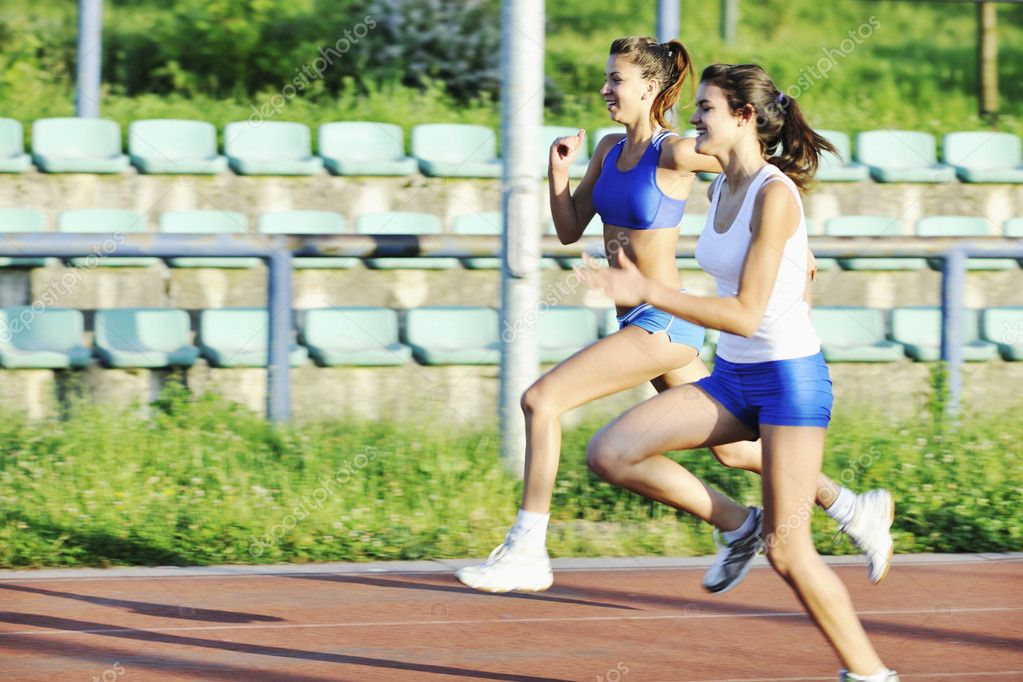 Two girls running on athletic race track — Stock Photo © .shock 3343748