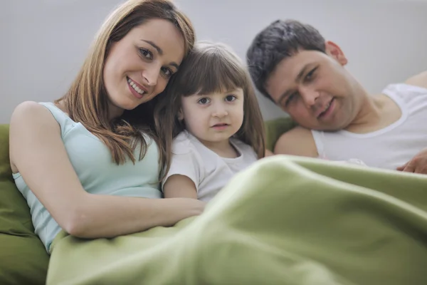 Ontspannen in bed en gelukkige familie — Stockfoto