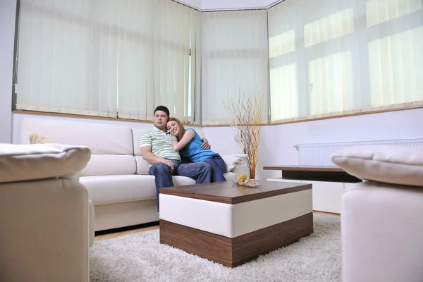Couple relax at home on sofa in living room Stock Picture