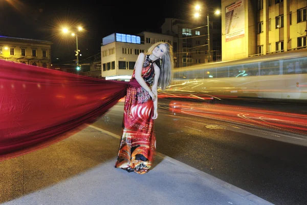 Elegant woman on city street at night — Stock Photo, Image