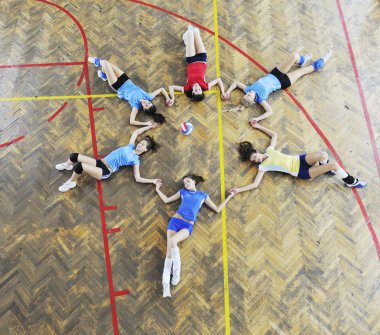 Girls playing volleyball indoor game clipart