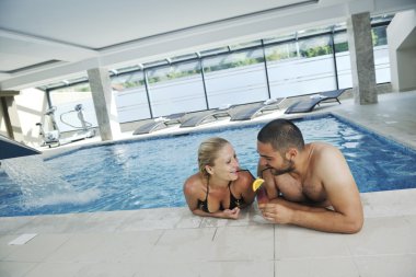 Happy cople at swimming pool clipart