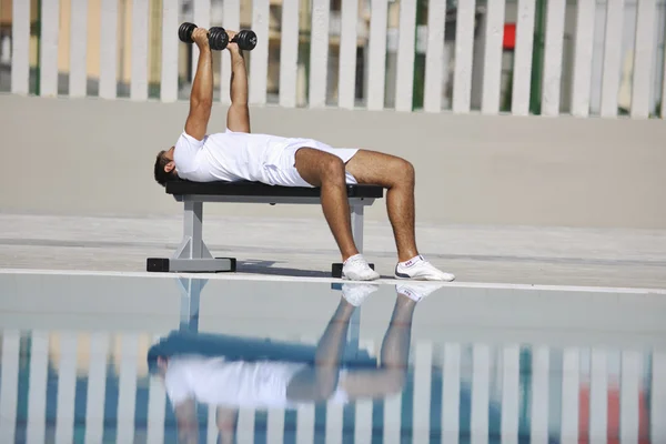 Ung frisk idrottare man motion vid poolen — Stockfoto