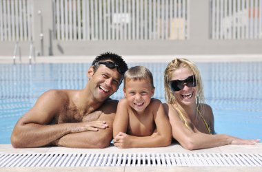 Happy young family have fun on swimming pool clipart