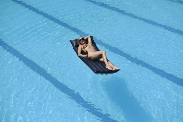 Mulher relaxar na piscina — Fotografia de Stock