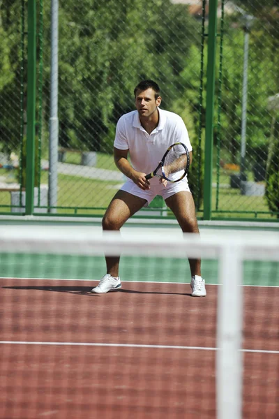 Young man play tennis outdoor Stock Picture