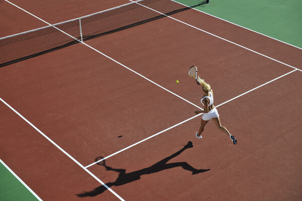 Молодая женщина играет в теннис
