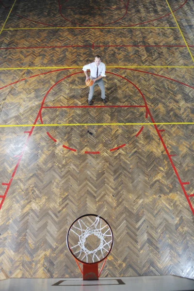 Üzletember holding kosárlabda labda — Stock Fotó