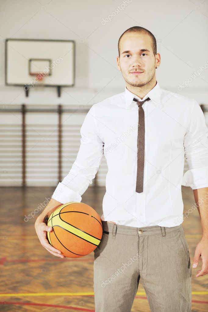 Businessman holding basketball ball