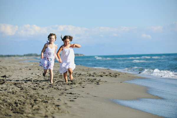 Happy young family in white clothing have fun at vacations on beautiful beach