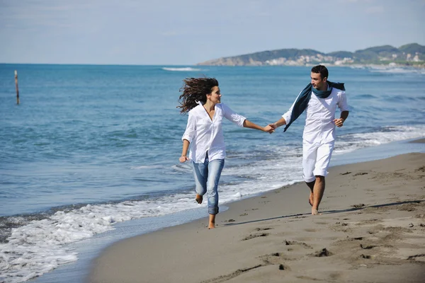 Feliz joven pareja divertirse en hermosa playa — Foto de Stock