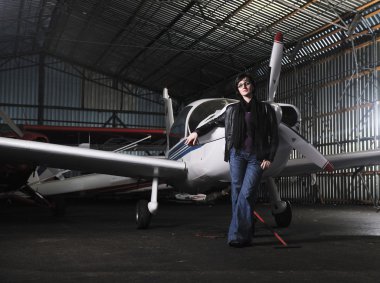 Young woman with private airplane clipart
