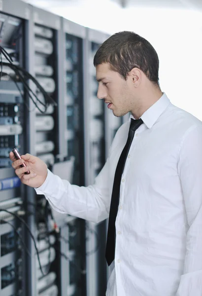 Young handsome business man it engineer in datacenter server room Stock Image